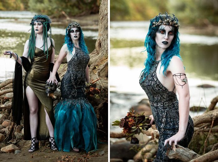 Two women in intricate Halloween costumes with dark makeup and blue hair posing by a riverside, showcasing genius Halloween costumes.