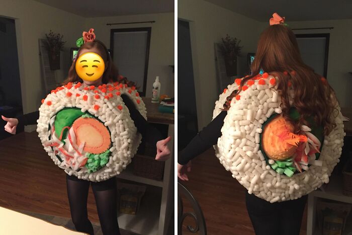 Person wearing a creative Halloween costume resembling a large sushi roll with colorful details and decorations
