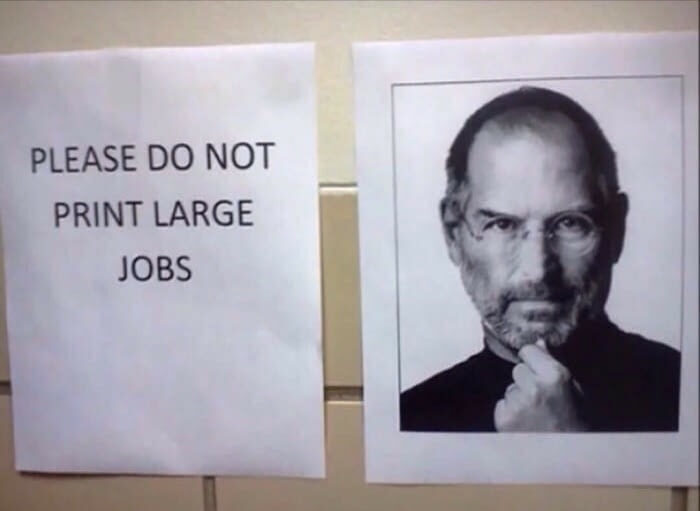 Passive-aggressive coworker notes including a printed sign that says do not print large jobs next to Steve Jobs photo.