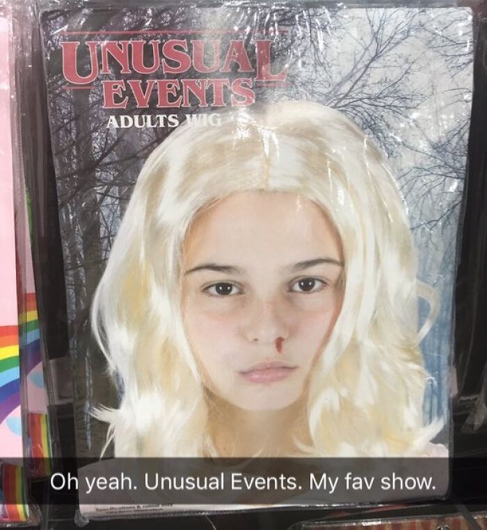 Off-brand Halloween costume wig packaging featuring a blonde adult wig labeled Unusual Events in an outdoor setting.