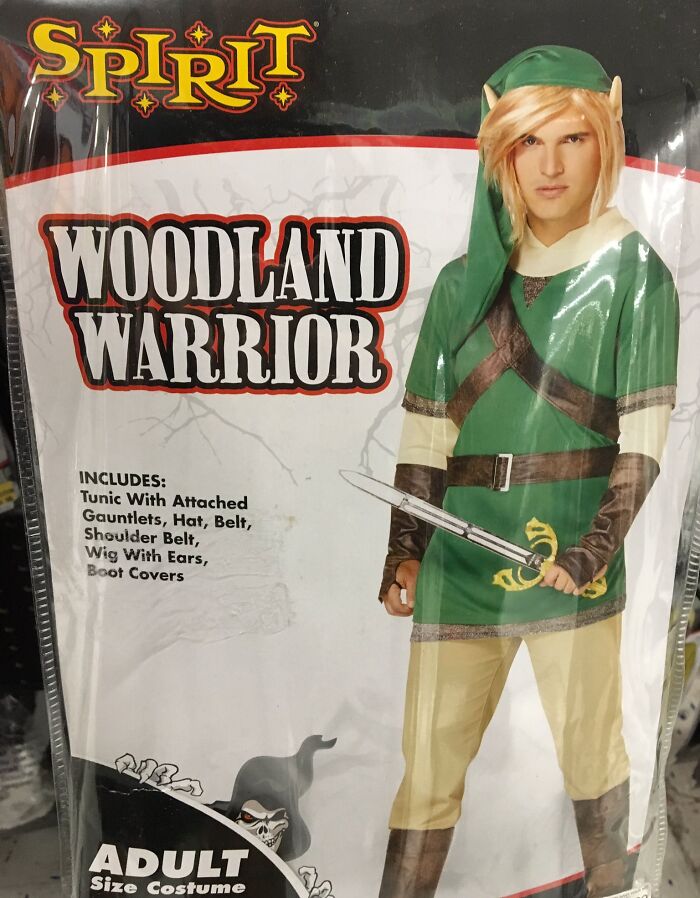 Off-brand Woodland Warrior Halloween costume with green tunic, hat, wig with ears, belt, and boot covers for adults.