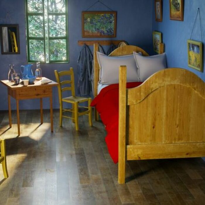 Cozy simple living bedroom with wooden furniture, blue walls, and natural light creating a minimalist and peaceful space.