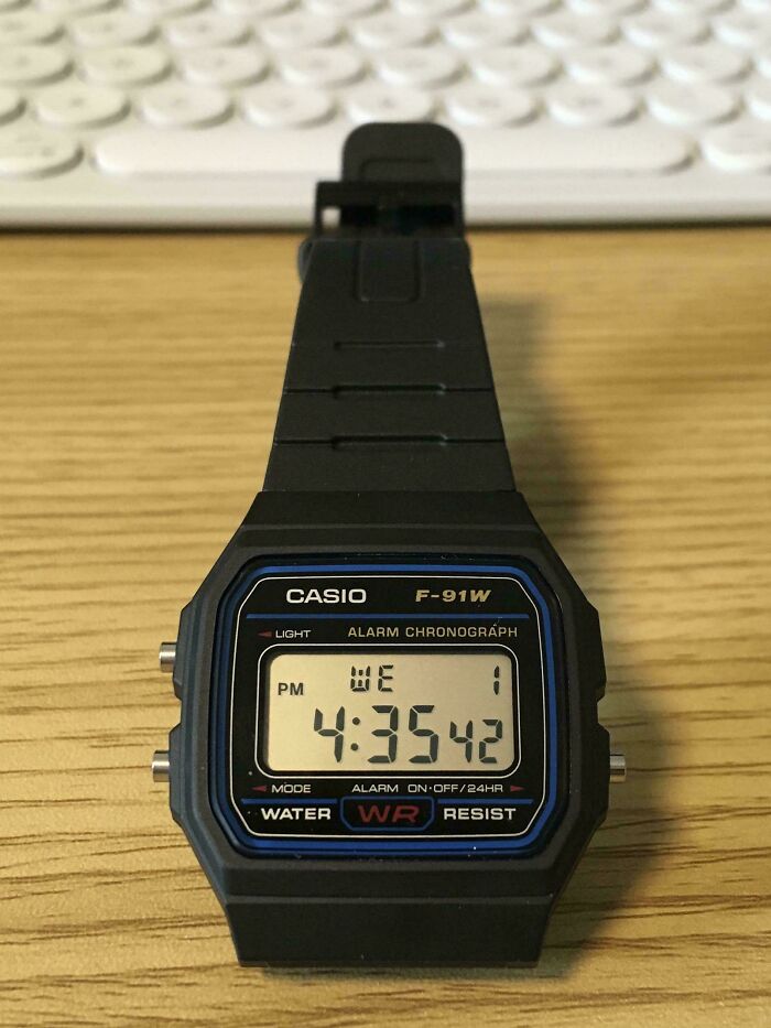 Minimalist Casio digital watch with a simple design on a wooden surface, embodying the essence of simple living.