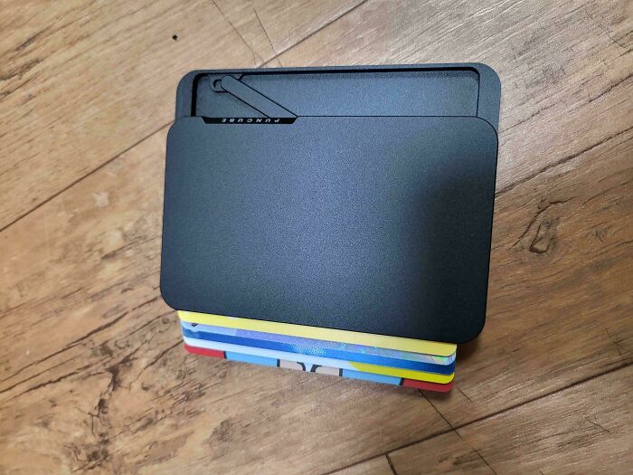 Minimalist wallet with multiple colorful cards inside, representing simple living and appreciating having less.