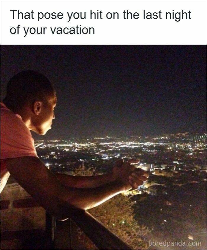 Person leaning on a railing at night overlooking city lights, capturing a specific moment in our lives not original experience.