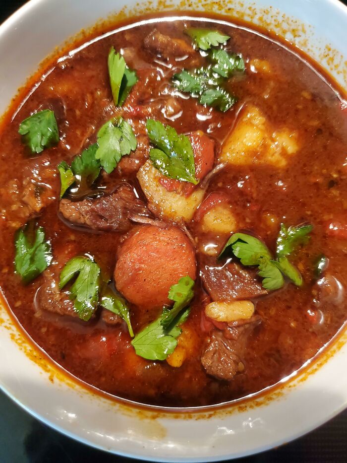 Hearty beef stew with carrots, potatoes, and fresh herbs, showcasing foods not popular in their country despite tourist appeal.