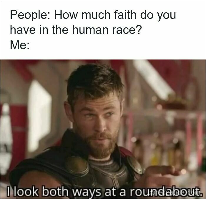 Man with beard humorously responding to having little faith in human race, a funny driving meme about road rage and roundabouts.