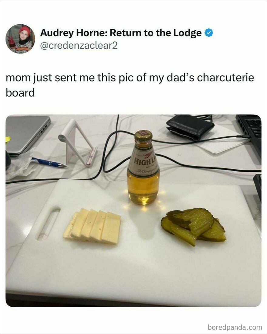 Minimalist dad charcuterie board with cheese slices, pickle chips, and a bottle of beer on a white cutting board.