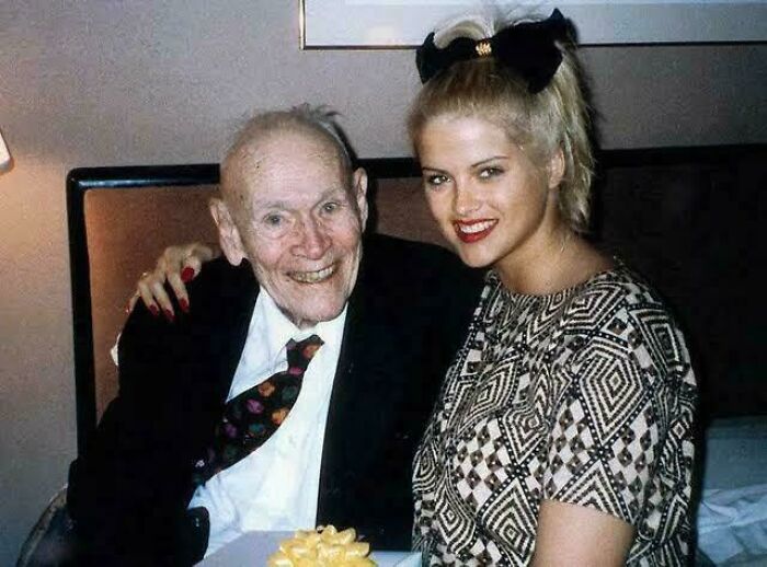 Elderly man and young woman smiling together, a fascinating photo capturing unique human connection and stories.