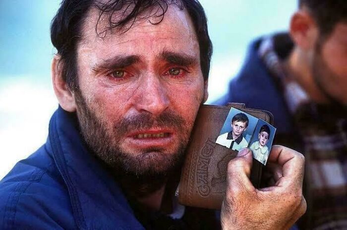 Man with weathered face holding a wallet with childhood photos, evoking emotion in fascinating photos that show the world differently