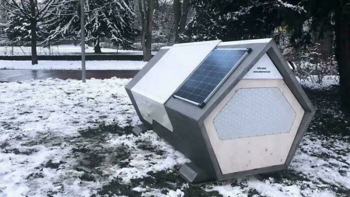 Modern hexagonal shelter with solar panels on snowy ground, showcasing fascinating photos and stories to see the world differently
