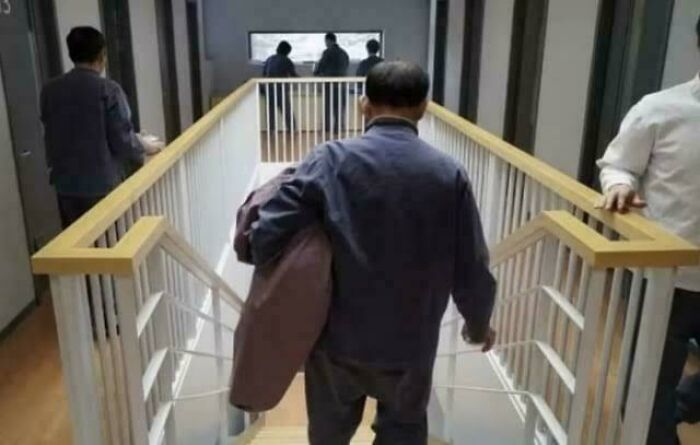 Man carrying another person on stairs in a unique photo illustrating fascinating moments that help see the world differently