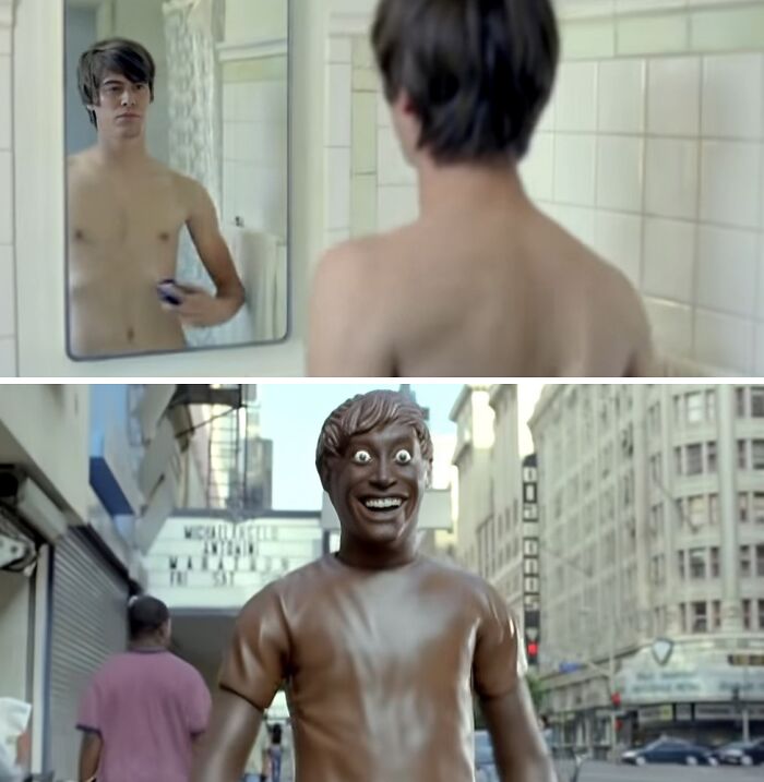Young man looking in mirror and a creepy smiling statue figure on city street from creepy commercials causing nightmares.