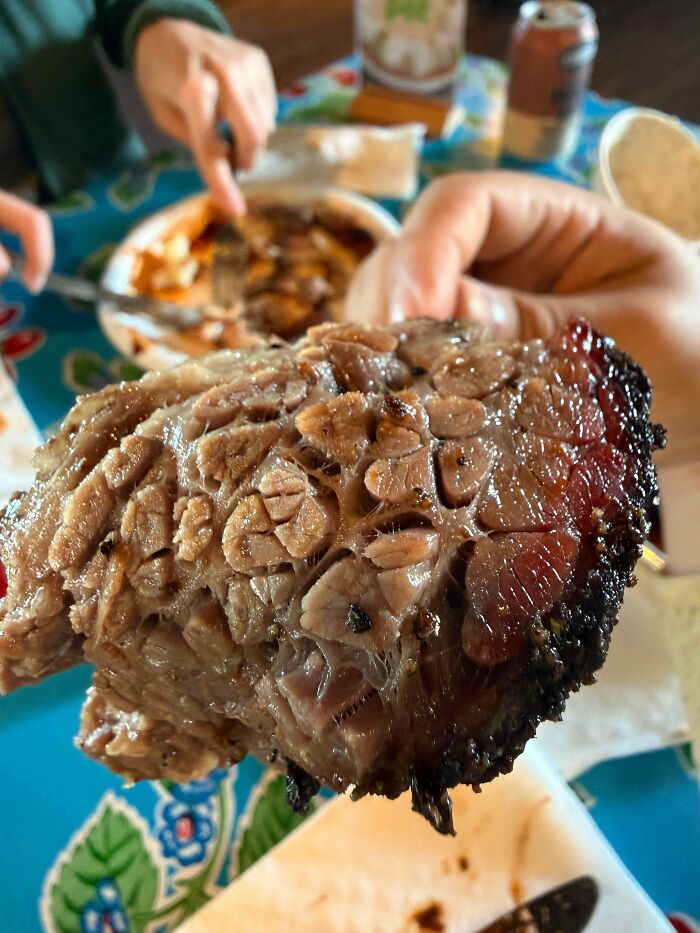 Close-up of cooked meat with a trypophobia-triggering pattern resembling clusters of holes and textures.