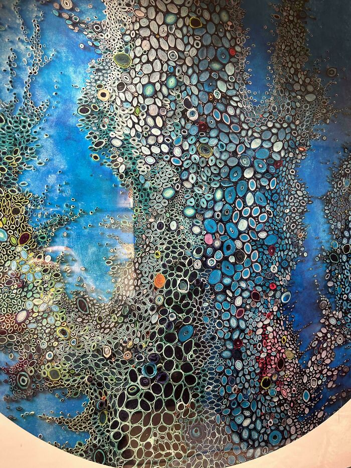 Abstract pattern of numerous clustered holes and ovals with blue and multicolor tones, triggering trypophobia reactions.