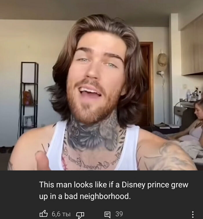 Man with tattoos and long hair in a casual room setting featuring hilarious YouTube comments better than the video.