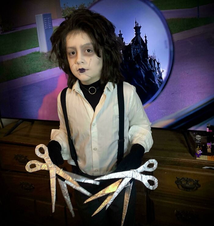 Child dressed in a creative Halloween costume with large scissor props, showcasing unique kids' Halloween costume ideas.