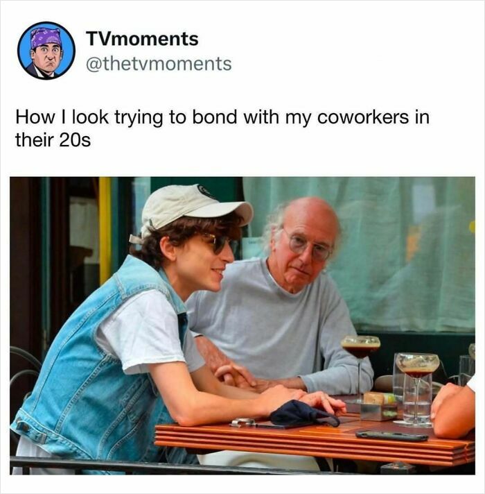 Man in a cap and denim vest trying to bond with older coworker, TV memes humor about workplace and age differences.