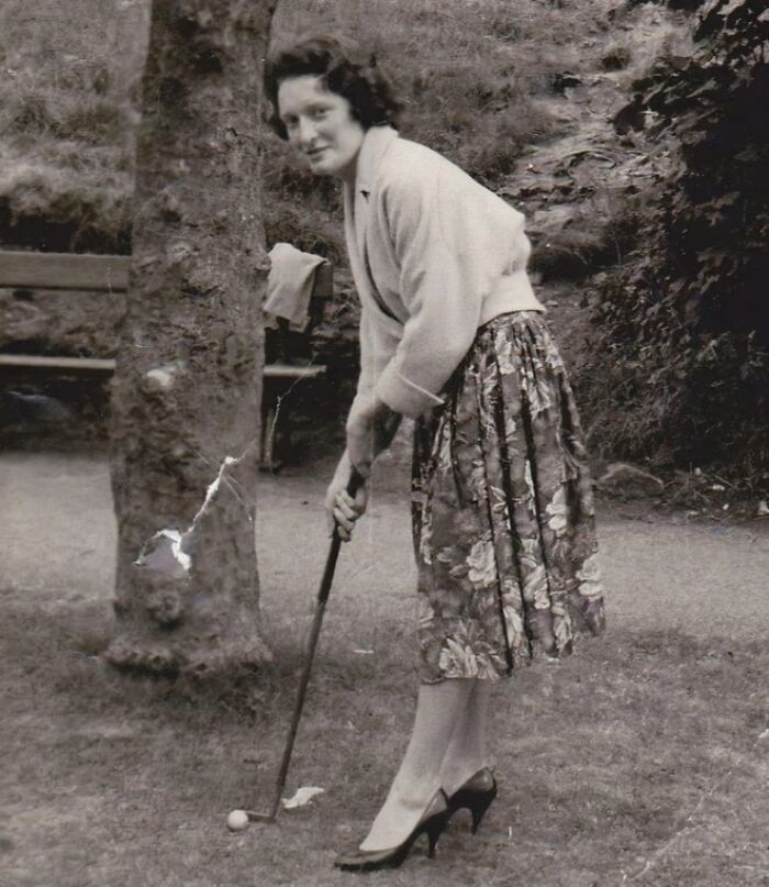 Vintage vacation pic of a woman playing golf outdoors, capturing a moment from before cell phones had cameras.