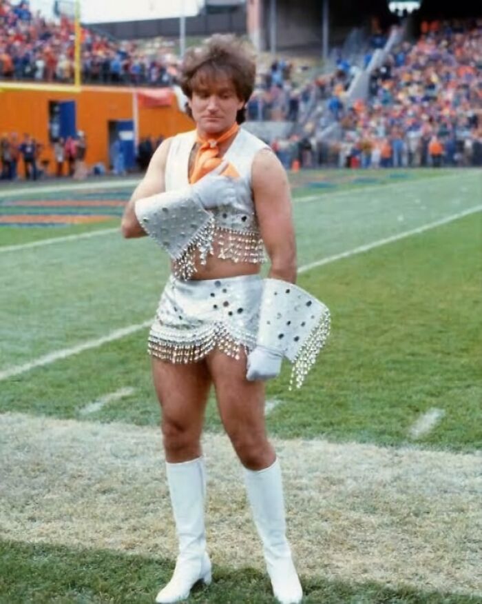 Man in a sparkling costume and white boots standing on a football field in fascinating photos that change perspective.