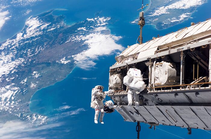 Astronauts performing a spacewalk outside the International Space Station showcasing epic astronomy and the beauty of space.