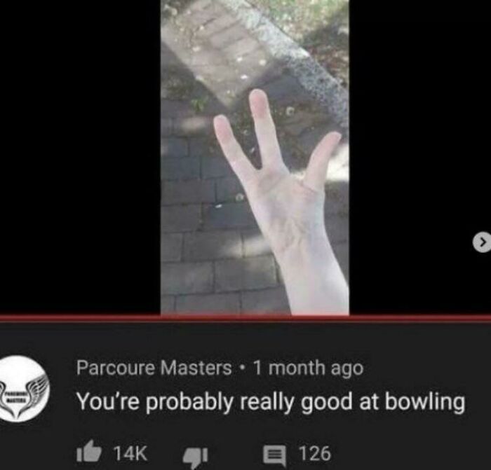 Funny YouTube comment praising bowling skills shown with a hand gesture on a paved outdoor path.
