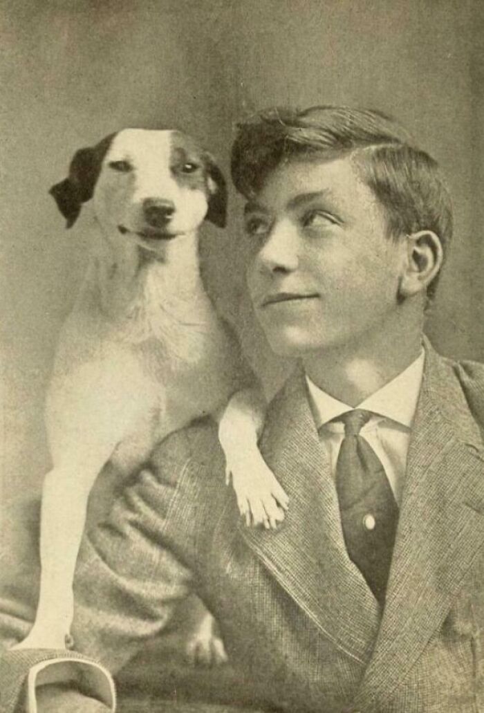 Vintage photo of a boy and his dog sharing a moment, showing fascinating emotions in photos that inspire seeing the world differently