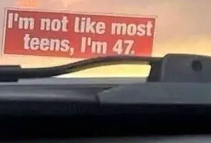 Funny bumper sticker on truck reading Im not like most teens Im 47, captured among clever and hilarious bumper stickers on the road.