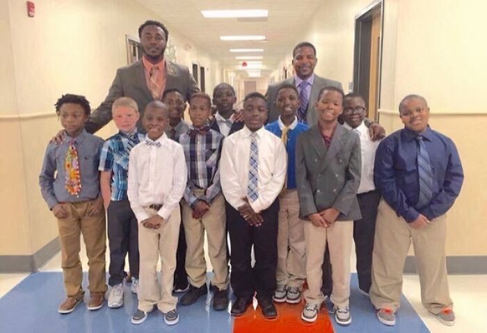 Group of young boys and two men dressed formally, showcasing positive role models and the good in the world.