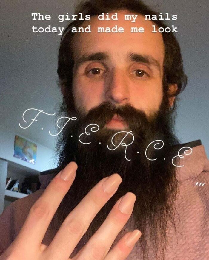 Bearded man showing his freshly done nails, highlighting men are good and kind gestures in this world.