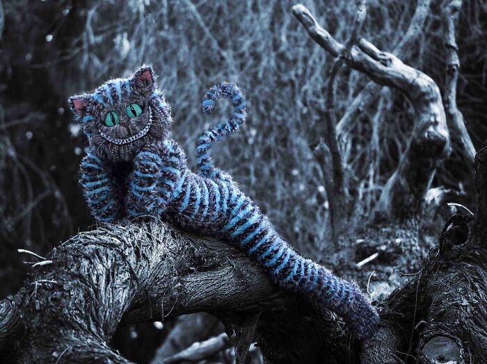Child dressed in an amazing kids Halloween costume as a magical Cheshire cat in a spooky forest setting.