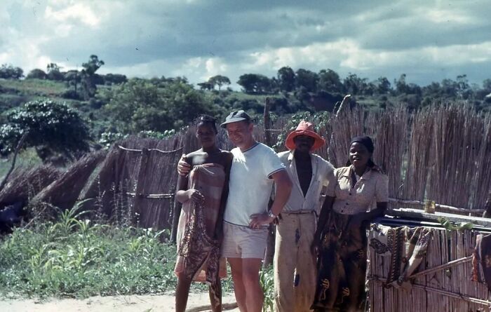 Vintage vacation pic showing a group posing outdoors near rustic fencing, capturing moments from before cell phone cameras existed.