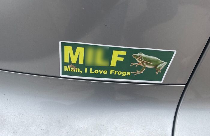Funny bumper sticker on a car with the phrase M**F Man I Love Frogs and an image of a green frog on the road.