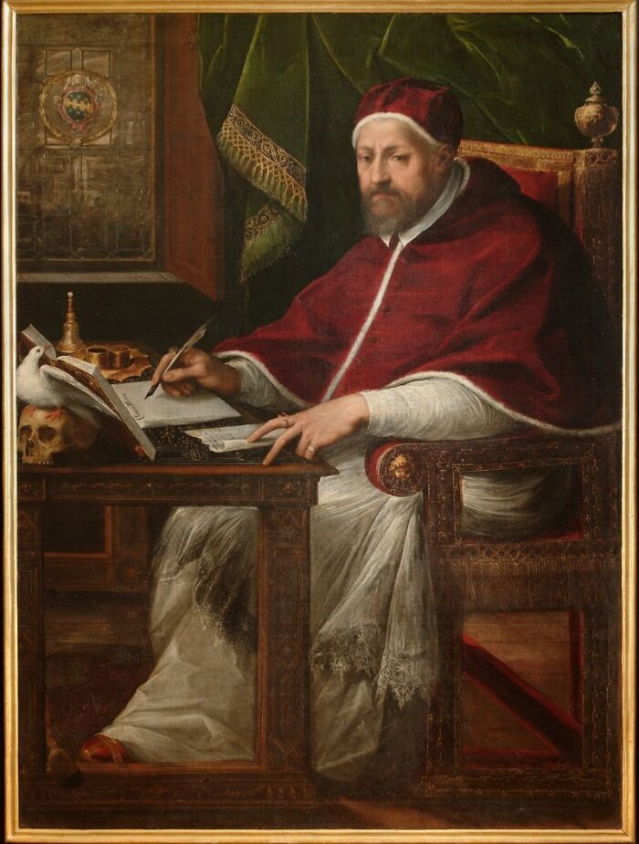 Portrait of a seated man in red robes writing at a desk with a skull and dove, historic scene related to rabbits and Napoleon.