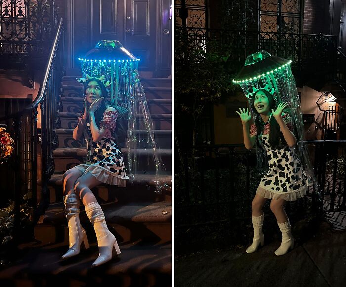 Young woman wearing a creative Halloween costume with LED jellyfish hat and cow print dress at night outdoors.