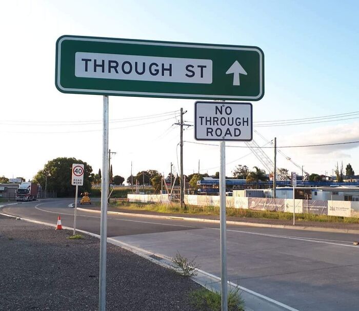 Confusing road signs with contradictory messages on a suburban street causing drivers to ignore GPS directions.