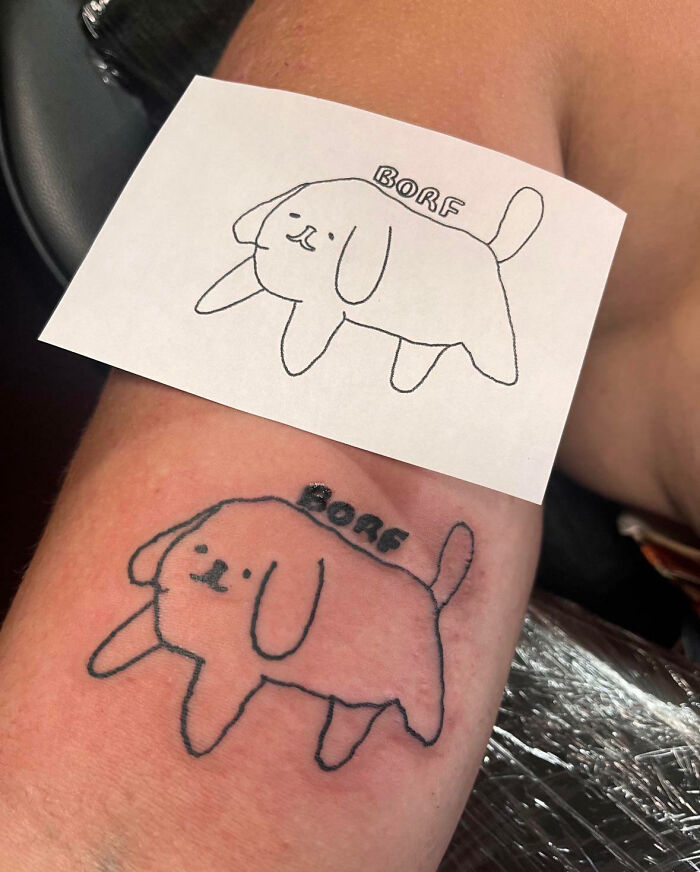 Simple dog tattoo and its drawn design on a piece of paper, a weird picture that looks both blessed and cursed.