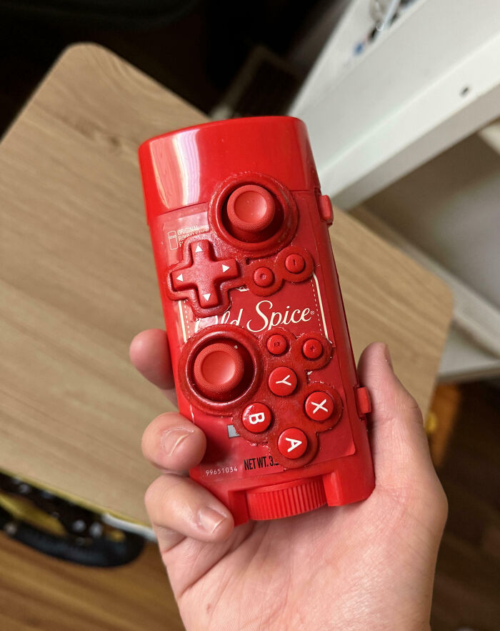 Red Spice deodorant container with weird, blessed and cursed video game controller buttons molded on it in a hand.
