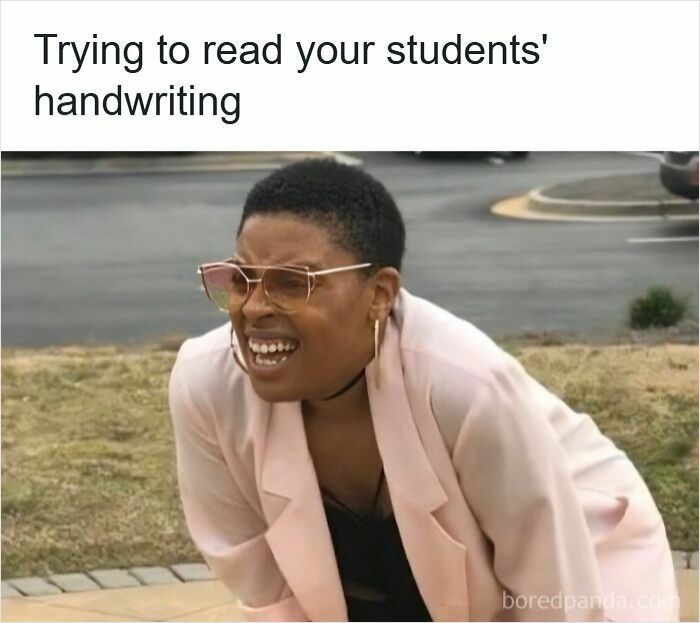Teacher squinting and struggling to read students' handwriting, highlighting funny memes for teachers who deserve a raise and a nap.