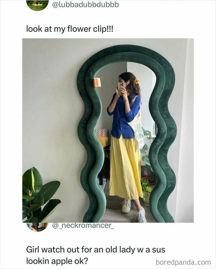 Young woman with flower hair clip takes mirror selfie, wearing blue shirt and yellow skirt, giving a daily serotonin boost.