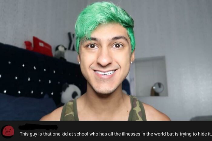 Smiling young man with green hair in a camo tank top, illustrating hilarious YouTube comments better than the video.