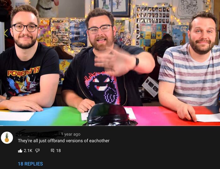 Three men sitting at a colorful table reading hilarious YouTube comments better than the video.