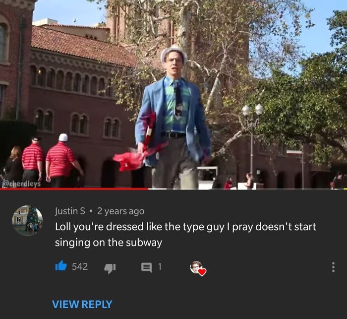 Man in colorful outfit walking outdoors with hilarious YouTube comments visible in the video screenshot.
