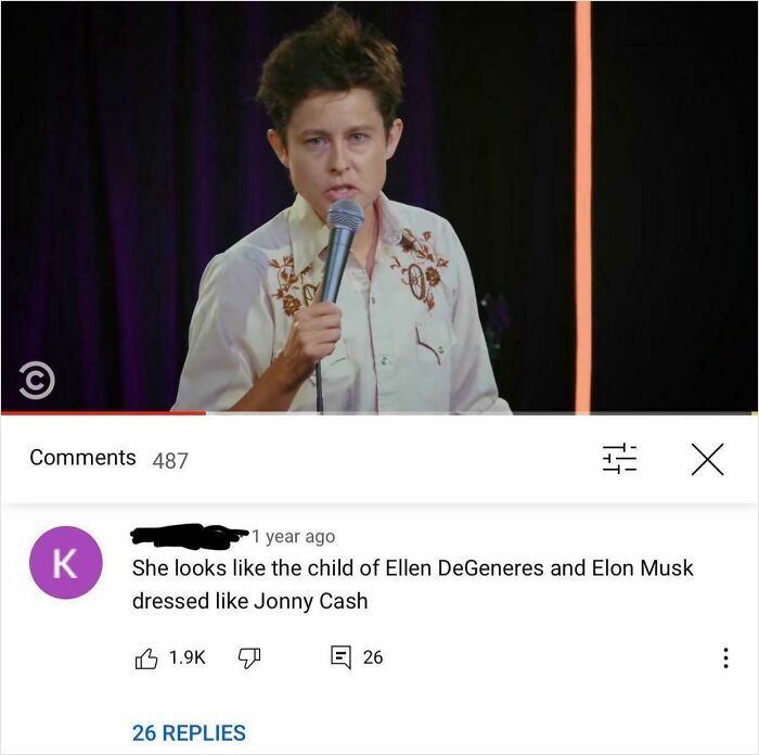 Stand-up comedian performing on stage with a microphone and hilarious YouTube comments visible below.