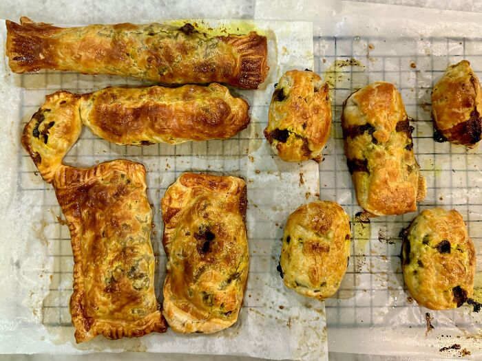 Baked pastries with uneven shapes and burnt spots, appearing unappetizing and visually disturbing food in a kitchen setting