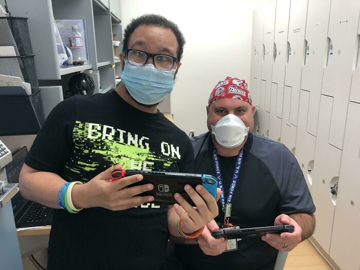 Two doctors wearing masks and playing Nintendo Switch to put patients at ease in a wholesome and hilarious way.