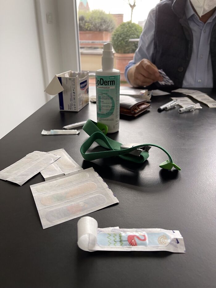 Medical supplies and colorful bandages on a table with a doctor preparing to put patients at ease.