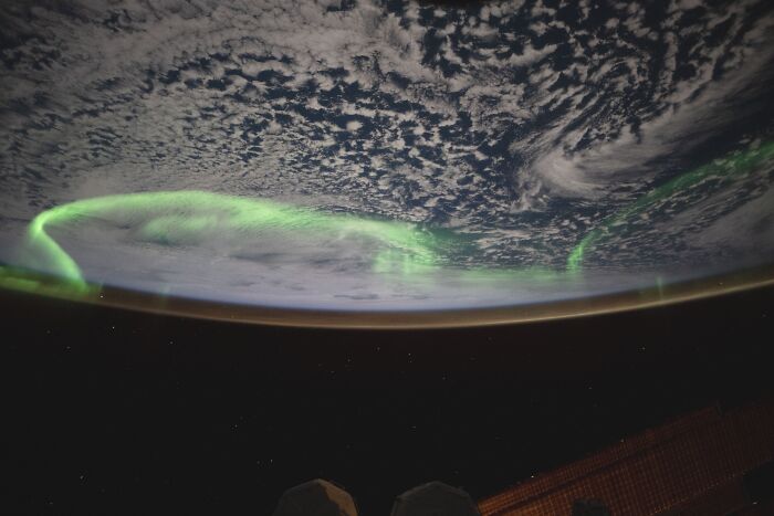 Aurora borealis glowing over Earth’s horizon, captured in an epic astronomy photo revealing space’s beauty and mystery.