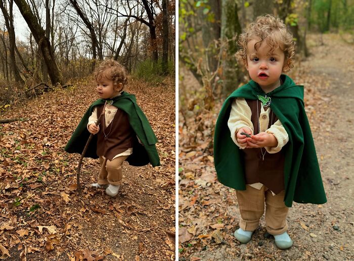 Toddler dressed in an amazing kids Halloween costume with green cape and walking stick in a forest setting outdoors.