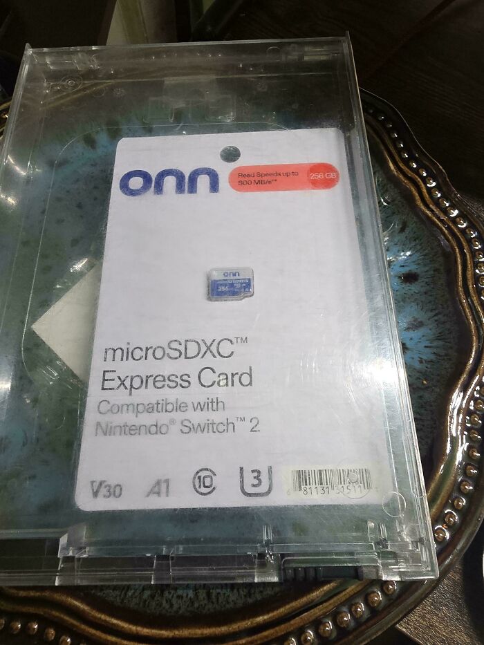 Clear plastic case containing a tiny microSDXC Express Card for Nintendo Switch, illustrating careless online shopping backfired moments.
